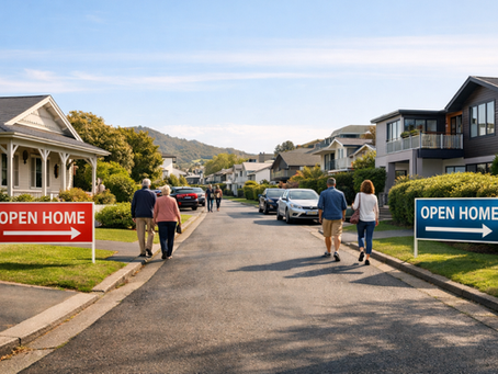 A suburban street with people walking toward two open home signs, one red on the left and one blue on the right. The setting is sunny and relaxed.