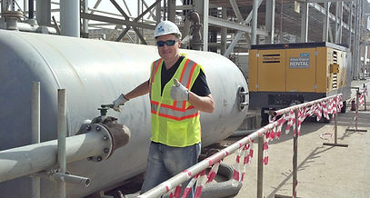 Engineer smiling, with thumbs up signaling ok.