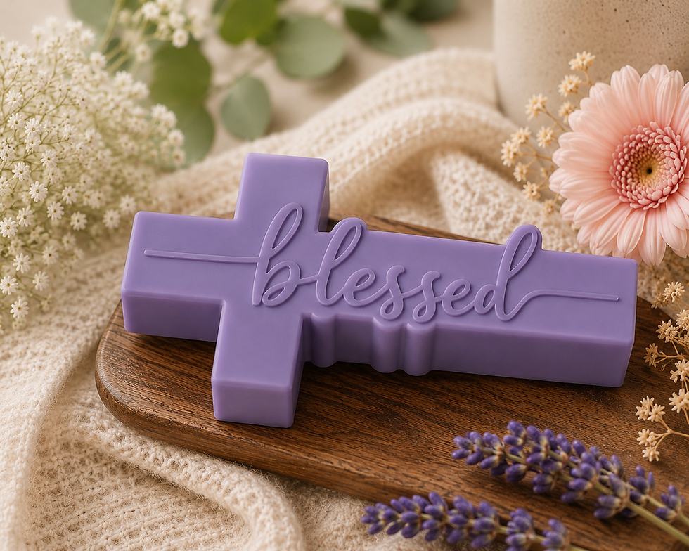 Purple hand made cross shaped soap with " Blessed" embossed on the front.