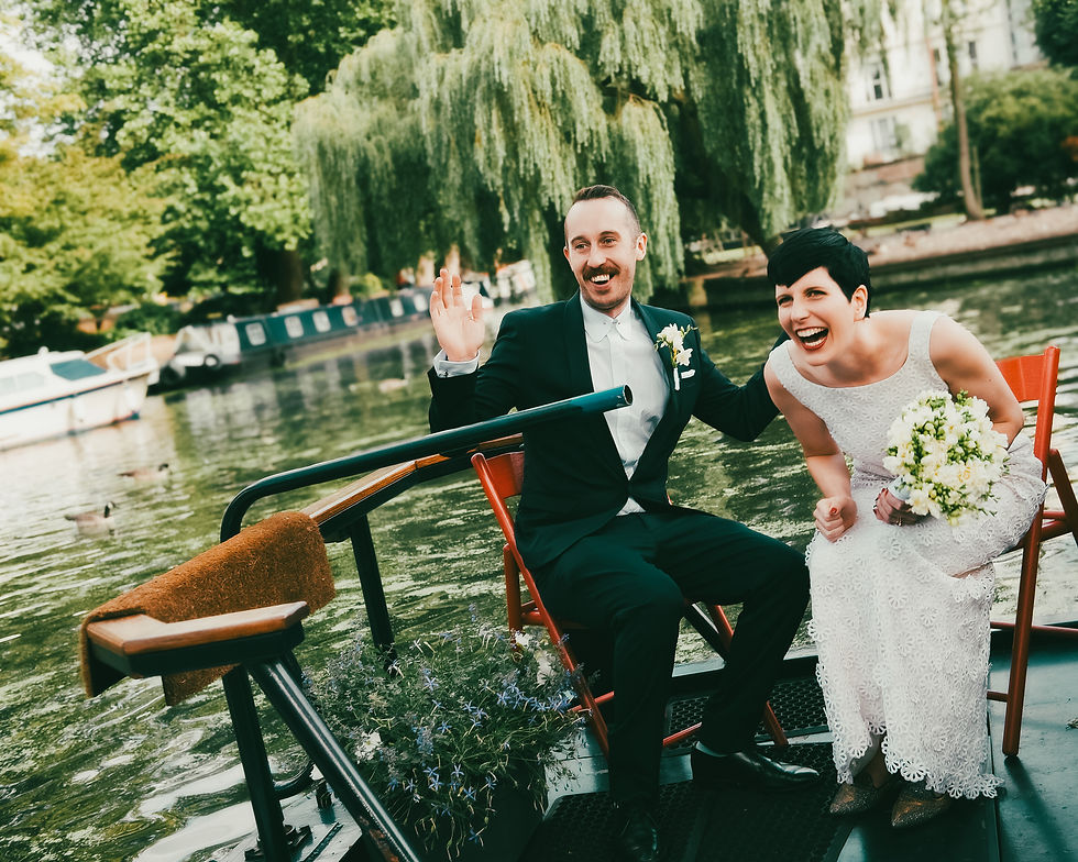 Laughing bride and groom on a boat in the UK