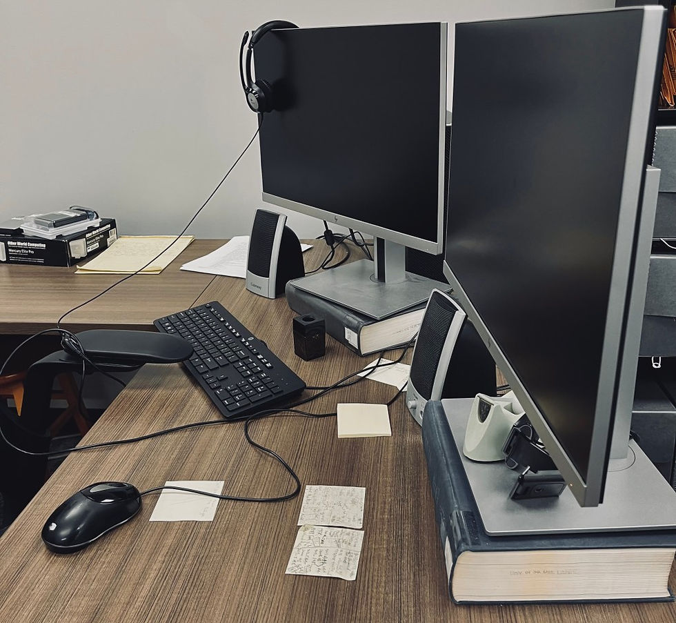 Dual monitors and headset at a transcription workstation.