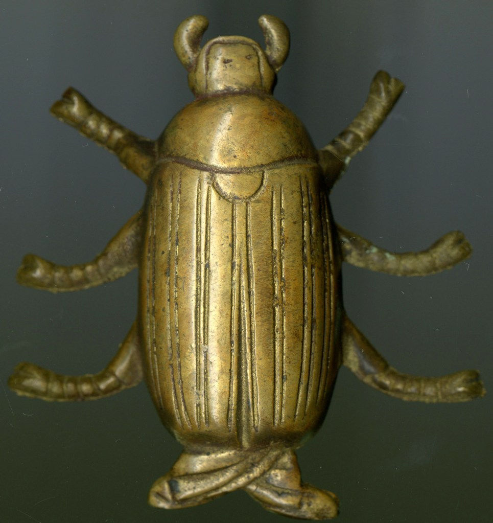 gold-colored metal beetle