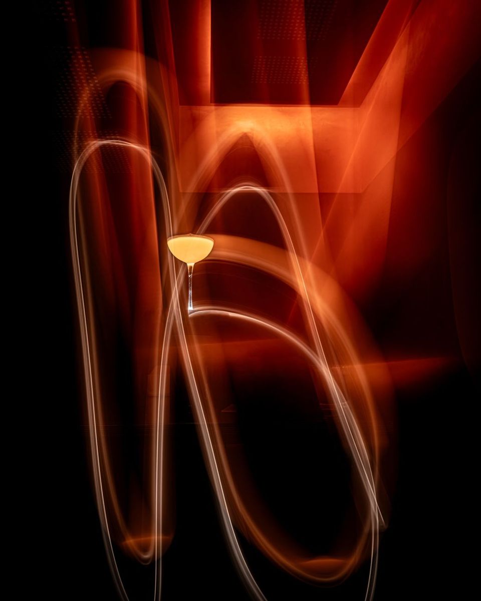 Trails of light around a cocktail glass