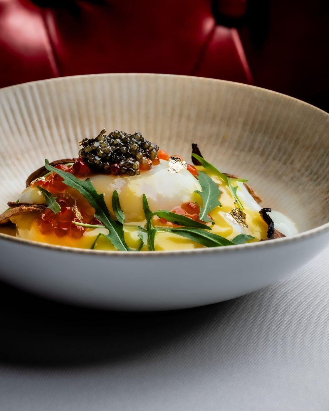 Burrata with caviar in a white bowl