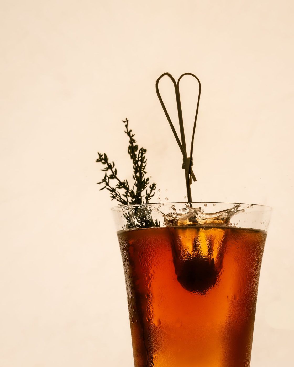 Amber cocktail with thyme