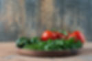 wooden-plate-with-cucumbers-greens-tomatoes.jpg
