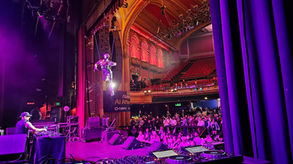 Aerial disco ball performer suspended inside a mirrored installation creating a dazzling luxury entertainment experience at a corporate event