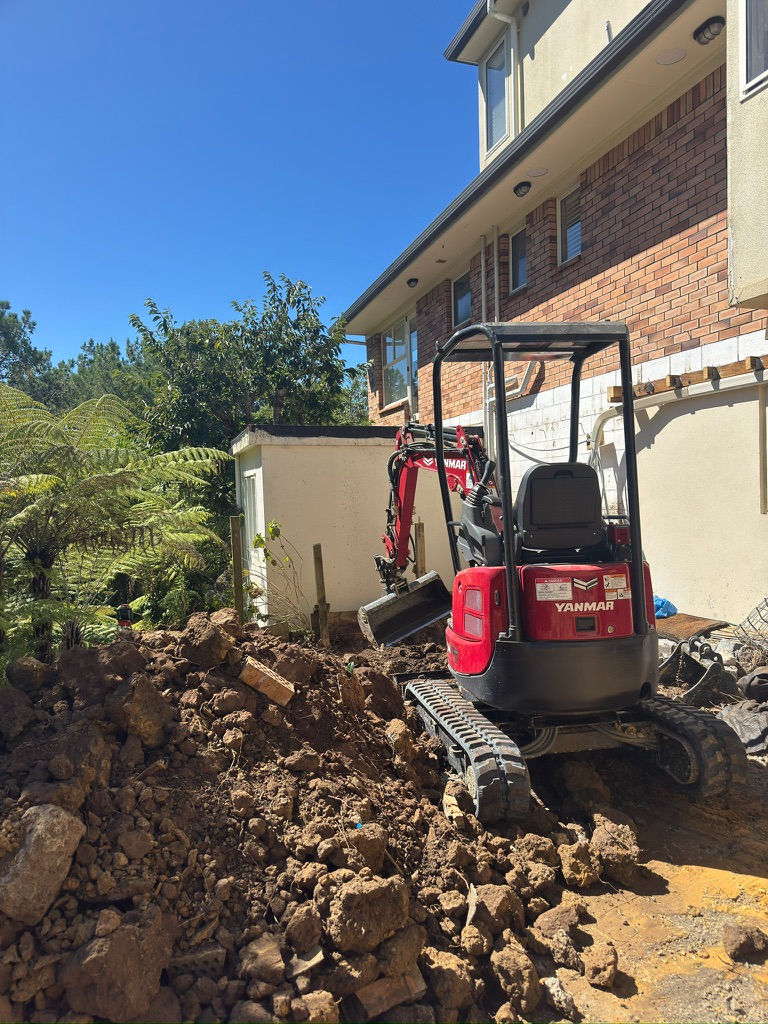 Yanmar mini excavator from Forge Hire on a client site in Auckland backyard, perfect for tight-access digger hire and excavation work.