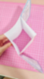 photo of the booklet being folded from the top