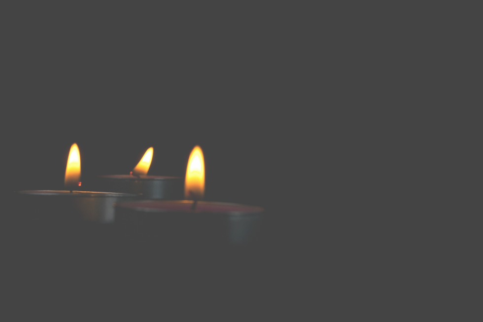 A Close-up of lighting candle with yello