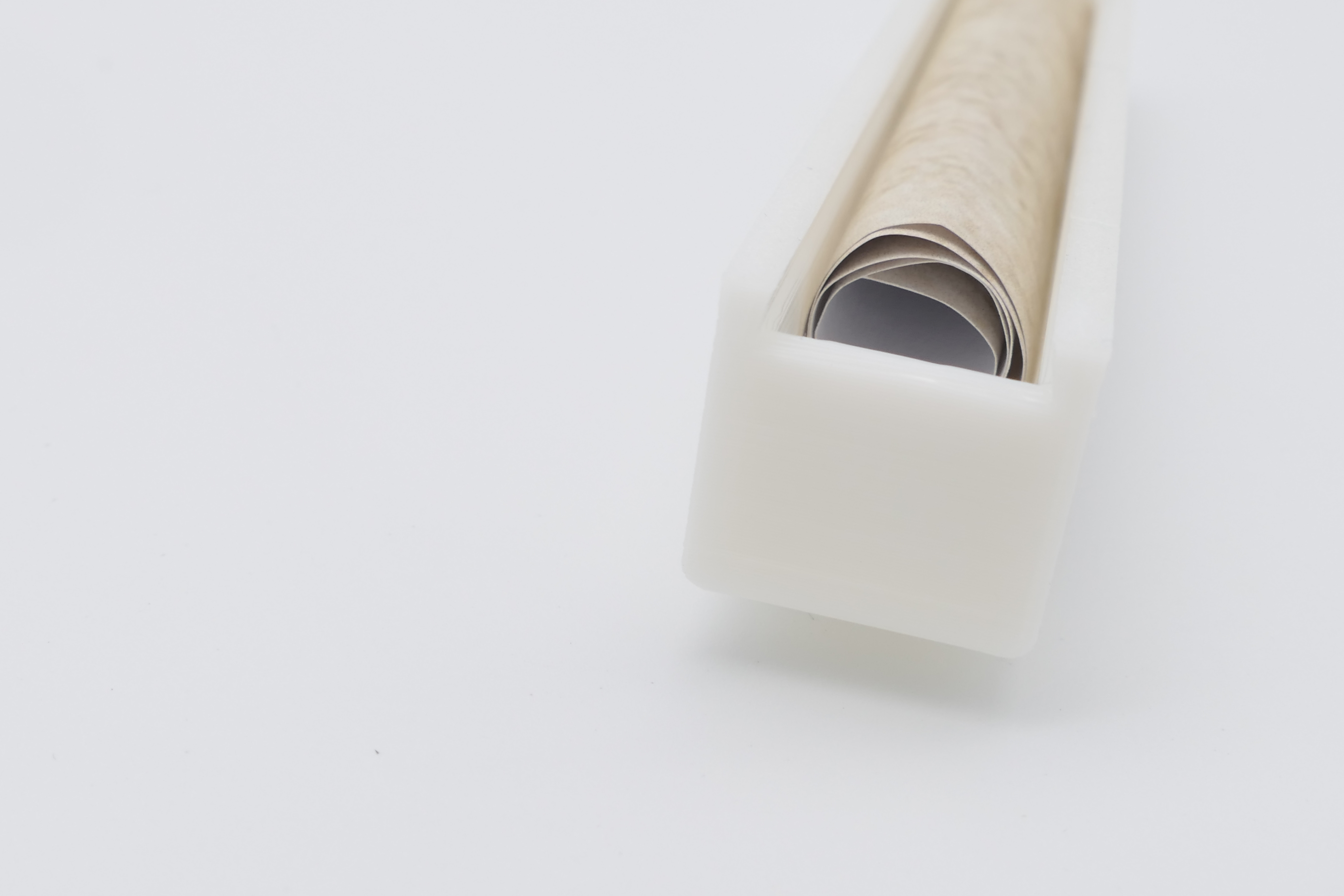 Side view of the scroll in the white case, part of the complete Mezuzah craft set for teens