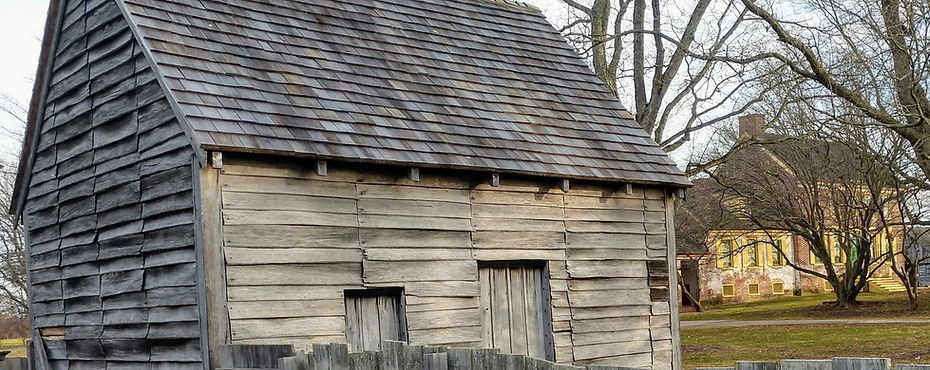 a wooden structure sitting in front of a large house