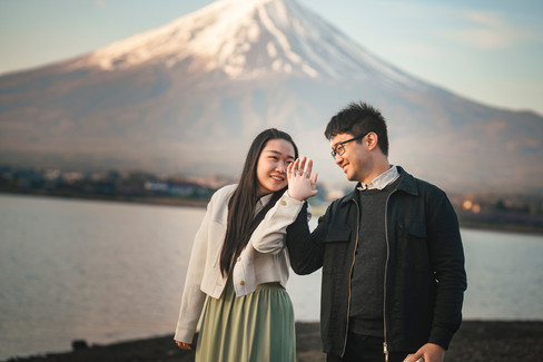 Bride-to-be showing her engagement ring with Mt. Fuji in the background after a surprise proposal in Japan