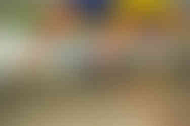 Couple walking hand-in-hand past colorful Shibuya wall art during a vibrant couple photo shoot in Tokyo, Japan