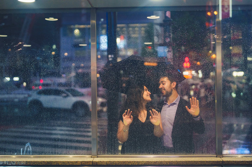 Couple smiling at each other through a rain-covered window in Shibuya