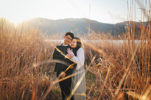 Couple portrait among golden reeds near Lake Kawaguchiko shortly after a sunrise proposal at Mt. Fuji