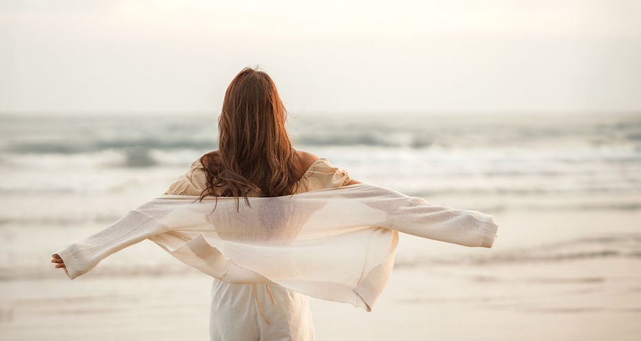 Happy young asian woman with freedom on the sea beach at golden sunset, Summer beach vacat