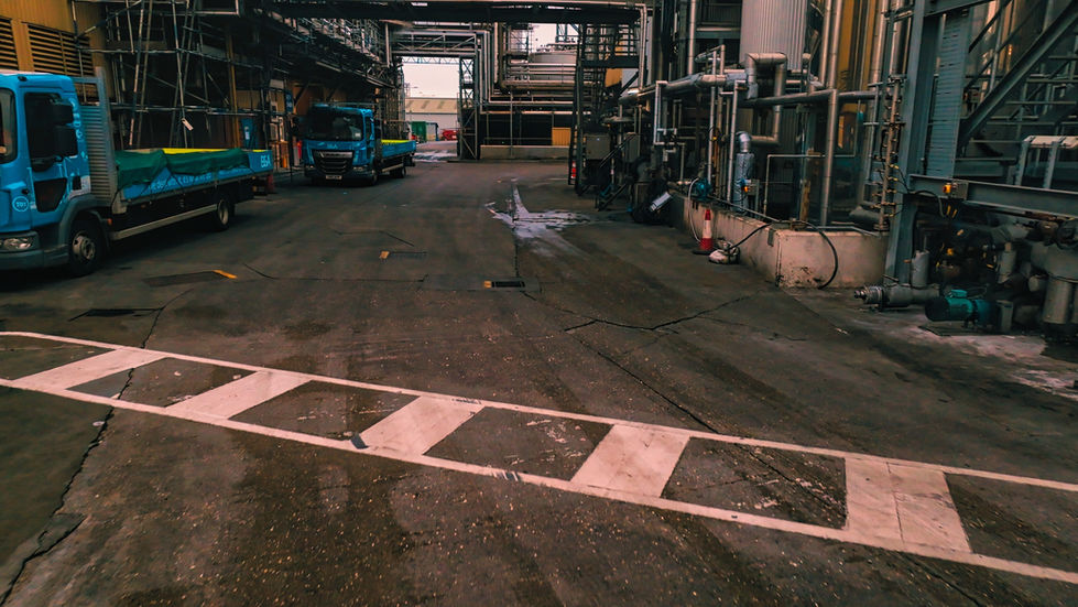 A white crossing inside an industrial plant.