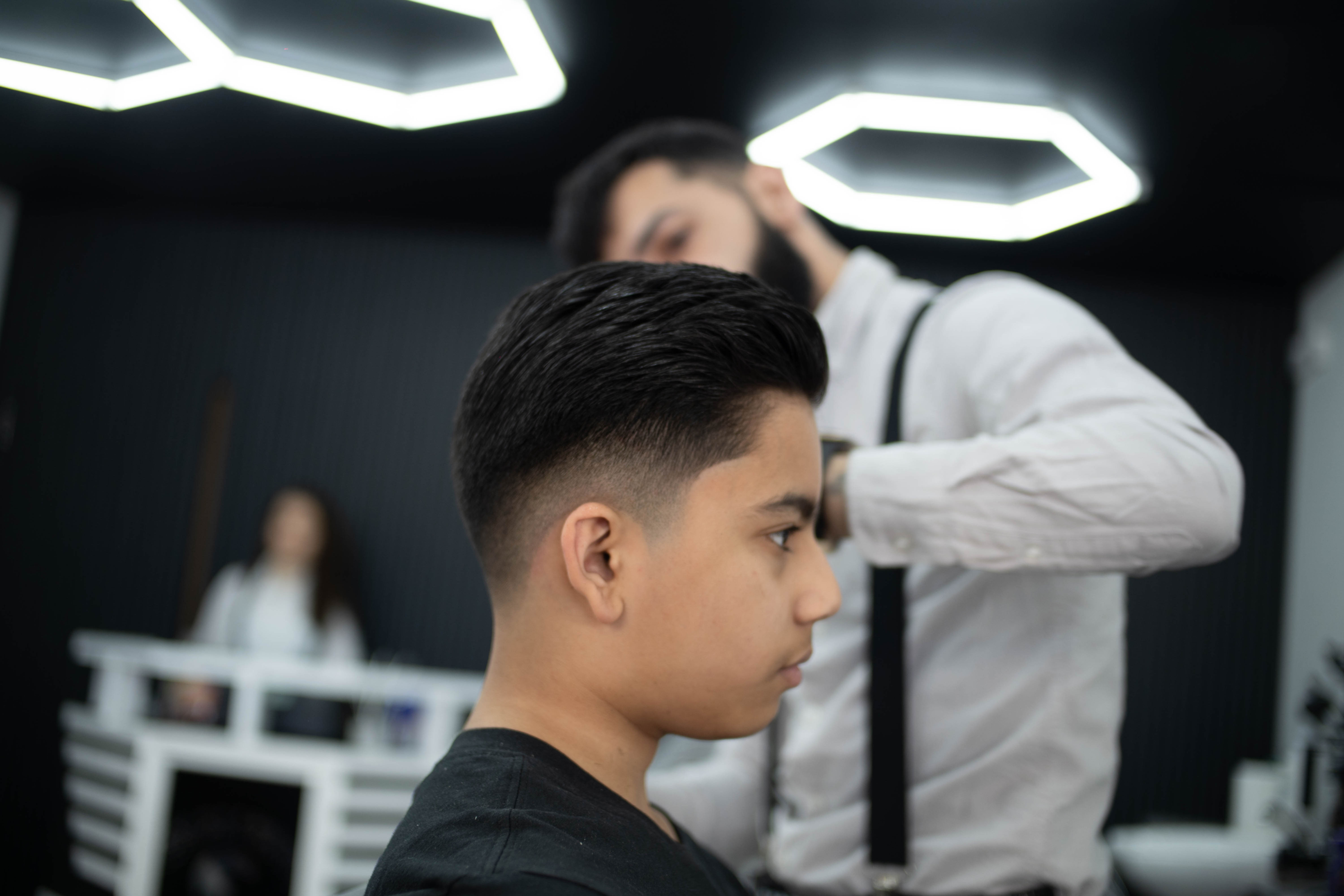 Happy child with a fresh, neatly styled haircut at The Millionhairs barbershop in Wapping