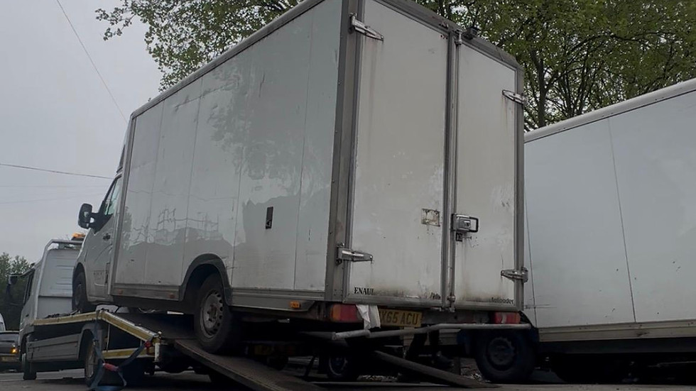 White box truck on transport ramps
