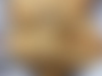 Warm, golden flatbreads on a blue-striped towel. Freshly baked with a rustic texture, set outdoors with a blurred background.