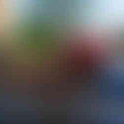 Red crochet amigurumi razorback hog sitting on top of a rusty old ford tractor.