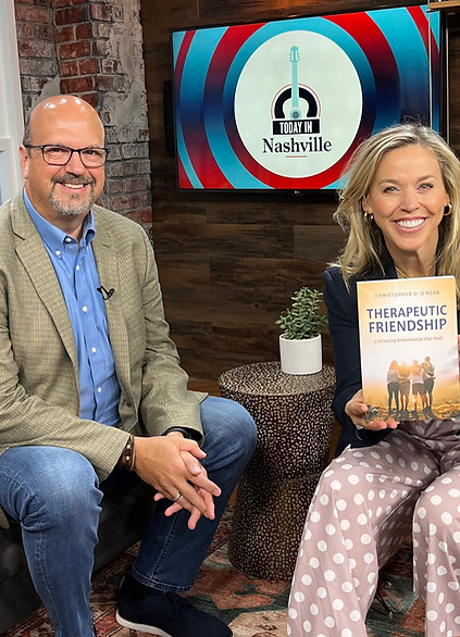 Chris O’Rear on the set of Today in Nashville with host holding his book Therapeutic Friendship: Cultivating Relationships That Heal.