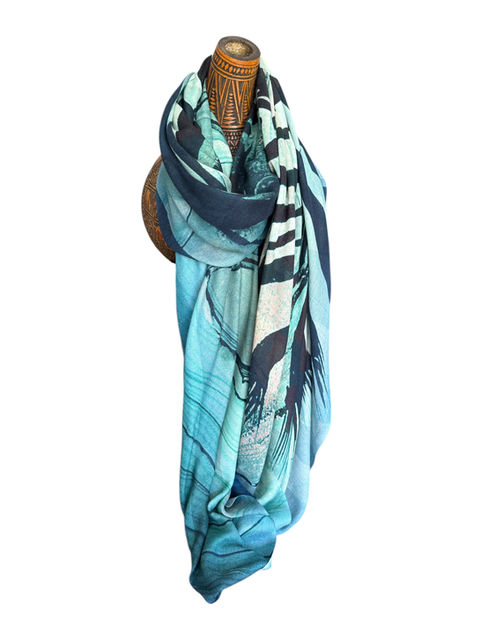 Blue cashmere scarf with artistic zebra design, showing two zebras embracing, draped on a mannequin.