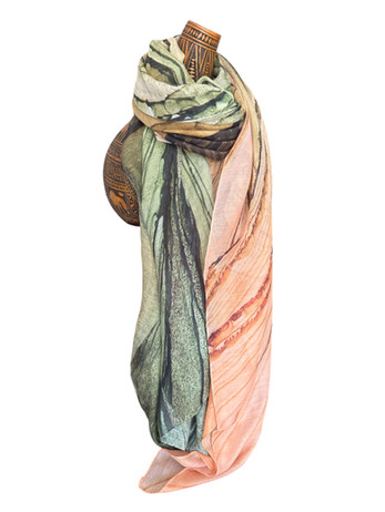 Green and peach silk scarf with abstract sunset gorge patterns, draped on a mannequin.