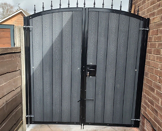 High gate on a driveway in grey and black