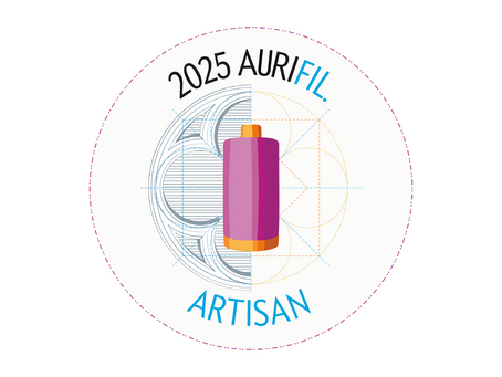 Aurifil Artisan 2025 badge featuring a pink thread spool over a geometric background, with the words '2025 Aurifil Artisan' in black and blue text above and below the spool.