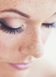 Beautiful bold makeup on a woman with freckles