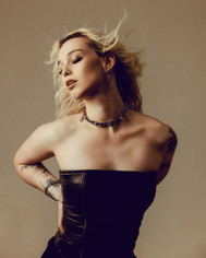 Avalon Stone in a spiked choker and corset, her hair blowing in the wind
