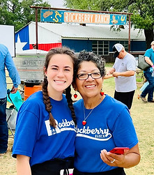 Two Rockberry Ranch workers smiling together on site.