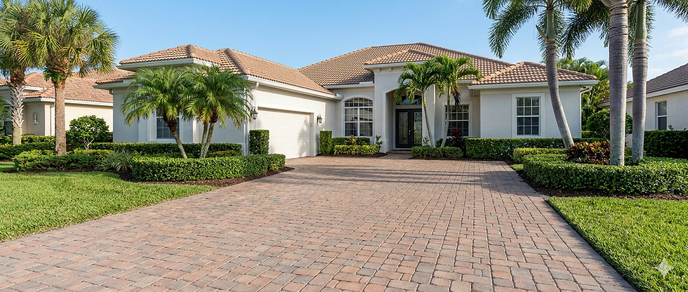 Port St. Lucie home with clean roof, freshly cleaned paver driveway, and exterior cleaning results by Clean Master Exterior Services