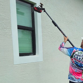 Water-fed pole window cleaning on residential exterior in Port St. Lucie