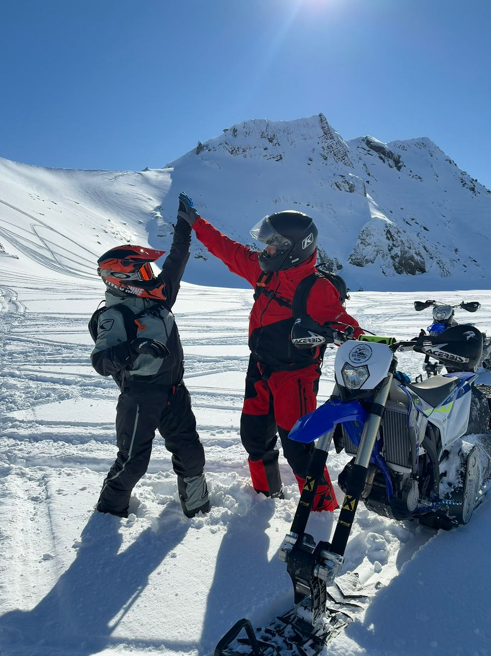 Happy snowbike riders with Arctic Tailblazers