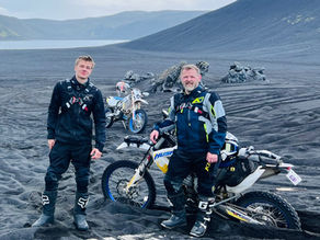 Óskar and a rider in black lava sand on a tour with Arctic Trailblazers