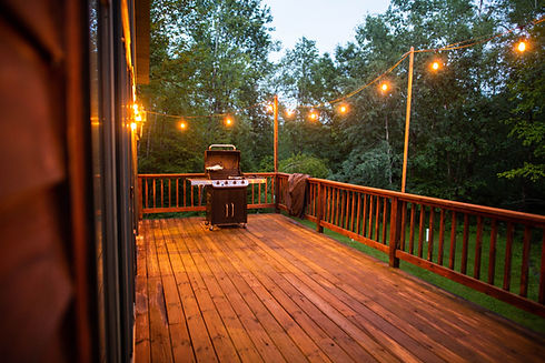 wooden-porch-with-string-lights-and-grill-2023-11-27-05-16-13-utc.jpg