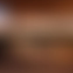 Outdoor patio at sunset with cozy seating, pillows, and glowing lanterns. A warm, peaceful ambiance with soft, earthy colors.