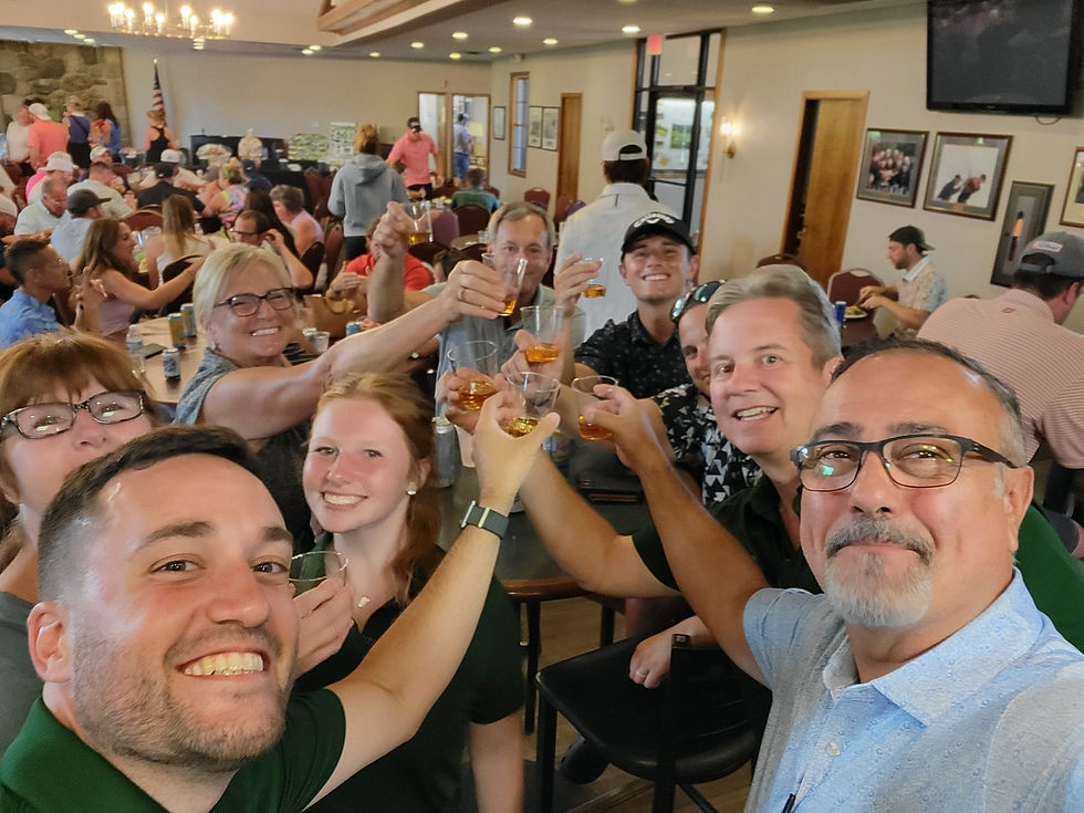 Group of family and friends smiling and raising their glasses