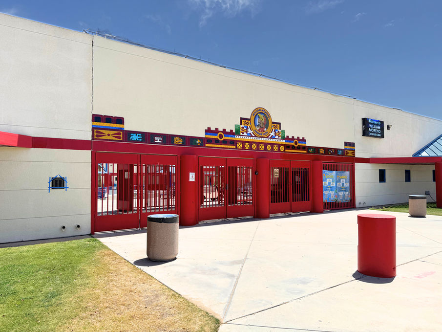 Close-up of the decorative school entrance showcasing architectural elements and mosaic detailing.