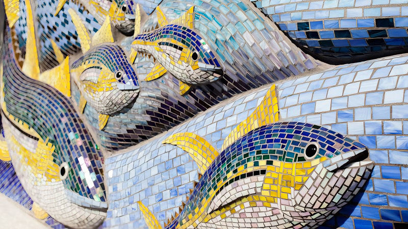 Angled close-up of glass tile textures on fish mosaic.