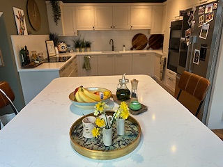 Modern kitchens in Seaton with a white island and fruit bowl