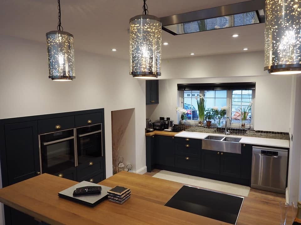 Modern dark blue kitchen in Exmouth with oak worktops.