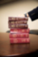 hand on stack of law books