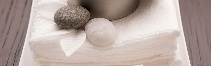 rlaxing image of towels, stones on couch