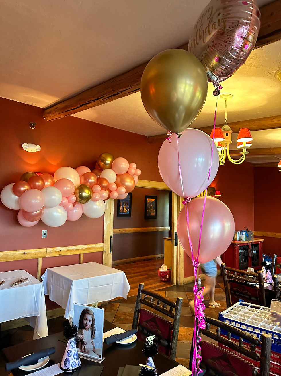 Thumbnail: Balloon garland and a centerpiece on the table. Colors: Gold, pink, pearl pink and a mylar happy birthday balloon on top