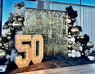 50th birthday balloon garlands with a silver shiny backdrop