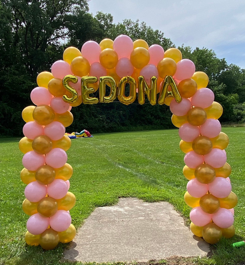 Small balloon arch. Colors: pink, gold and letter balloons saying "sedona" on top
